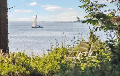 a bench with a sail boat in the water at Stunning Home In Fur With Wifi in Fur