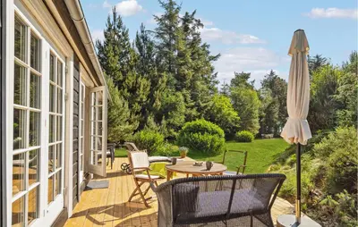 a patio with a table and an umbrella at Stunning Home In Fur With Wifi in Fur