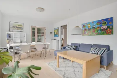 a living room with a blue couch and a table at Apartment in central Holstebro in Holstebro