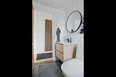 a bathroom with a toilet and a sink and a mirror at Apartment in central Holstebro in Holstebro