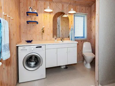 a bathroom with a washing machine and a sink at 6 person holiday home in Pandrup-By Traum in Pandrup