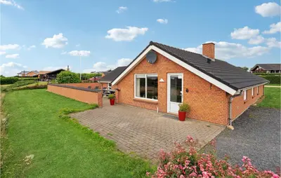 a red brick house with a brick driveway at Nice Home In Vinderup With Sauna in Vinderup
