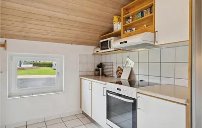 a kitchen with white appliances and a window at Nice Home In Vinderup With Sauna in Vinderup