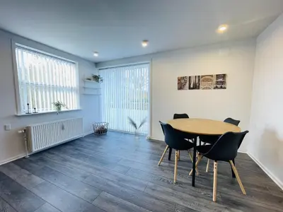 a dining room with a table and chairs at aday - Elegant Apartment with Terrace in Svenstrup