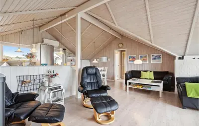 a living room with leather chairs and a couch at 3 Bedroom Cozy Home In Løgstør in Løgsted