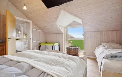 a bedroom with two beds and a large window at 3 Bedroom Cozy Home In Løgstør in Løgsted
