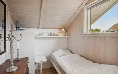 a small room with a bed and a window at 3 Bedroom Cozy Home In Løgstør in Løgsted
