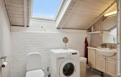 a bathroom with a washing machine and a sink at 3 Bedroom Cozy Home In Løgstør in Løgsted