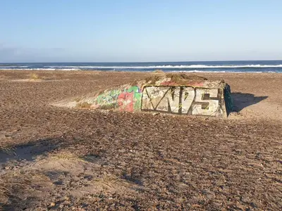 a rock covered in graffiti on a beach at 6 person holiday home in Fjerritslev-By Traum in Fjerritslev