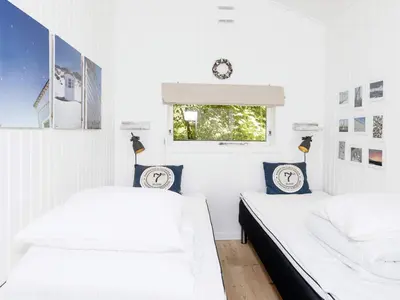 two beds in a room with white walls and a window at 6 person holiday home in Fjerritslev-By Traum in Fjerritslev