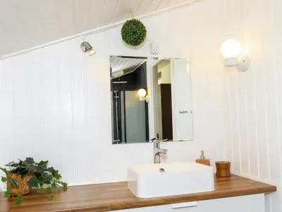 a bathroom with a white sink and a mirror at 6 person holiday home in Fjerritslev-By Traum in Fjerritslev