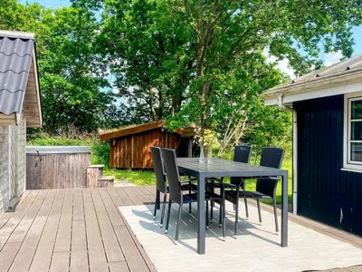 a black dining table and chairs on a patio at 4 person holiday home in Thisted-By Traum in Thisted