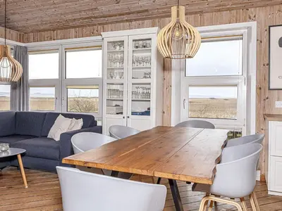a living room with a wooden table and chairs at 4 person holiday home in Thisted-By Traum in Thisted