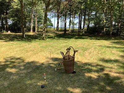 a basket with golf clubs and balls in a field at 8 person holiday home in Thyholm-By Traum in Thyholm