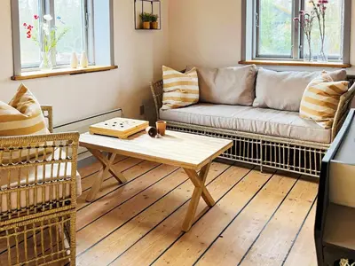 a living room with a couch and a coffee table at 8 person holiday home in Thyholm-By Traum in Thyholm
