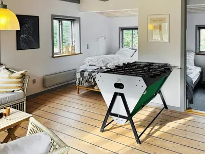 a living room with a ping pong table in it at 8 person holiday home in Thyholm-By Traum in Thyholm