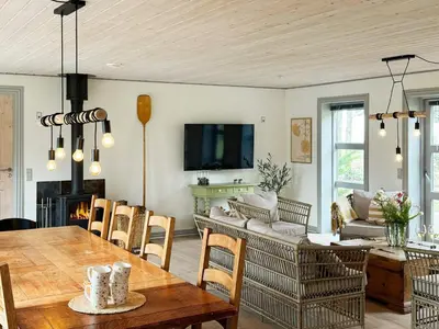 a living room with a table and a couch at 8 person holiday home in Thyholm-By Traum in Thyholm