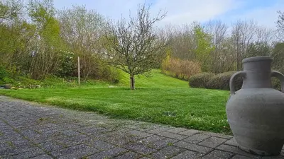 a large vase sitting on the side of a path at Gudum Park in Lemvig