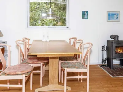 a dining room with a wooden table and chairs at 4 person holiday home in Hurup Thy-By Traum in Sønder Ydby