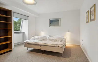 a white bedroom with a bed and a window at Cozy Home In Brovst With Kitchen in Brovst