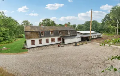 an aerial view of a house with a gravel driveway at Cozy Home In Brovst With Kitchen in Brovst