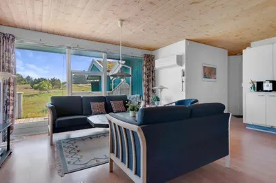 a living room with a couch and a table at Skytten 5 - Environmentally Friendly Holiday Home in Hune