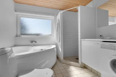 a white bathroom with a toilet and a sink at Skytten 5 - Environmentally Friendly Holiday Home in Hune