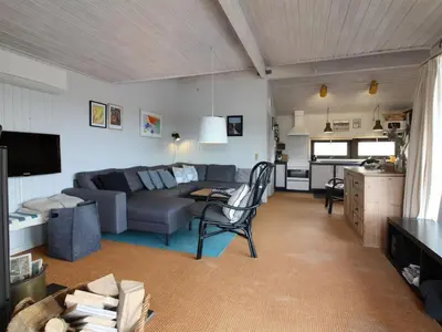 a living room with a couch and a table at Holiday Home Riitta - 300m from the sea by Interhome in Løkken