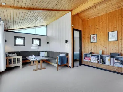 a living room with a couch and a table at Holiday Home Ilmari - 190m from the sea by Interhome in Pandrup
