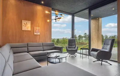 a living room with a couch and two chairs at Lovely Home In Højslev With Sauna in Højslev