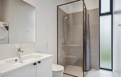 a bathroom with a shower and a sink and a toilet at Lovely Home In Højslev With Sauna in Højslev