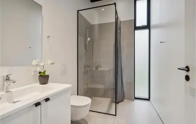 a bathroom with a shower and a toilet and a sink at Lovely Home In Højslev With Sauna in Højslev