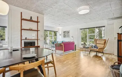 a living room with a table and chairs at Lovely Home In Hurup Thy in Sønder Ydby
