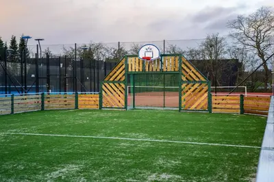 a playground with a basketball hoop on a court at Nice holiday home in beautiful resort in Farsø