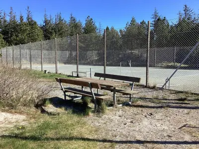 a wooden bench sitting in front of a fence at 8 person holiday home in Fjerritslev-By Traum in Fjerritslev