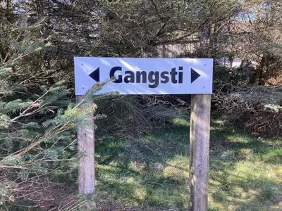 a street sign on two wooden poles with an arrow at 8 person holiday home in Fjerritslev-By Traum in Fjerritslev