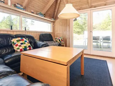 a living room with a couch and a table at 8 person holiday home in Fjerritslev-By Traum in Fjerritslev