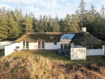 a large white house with a thatched roof at 8 person holiday home in Fjerritslev-By Traum in Fjerritslev