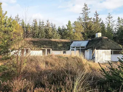an old house with a thatched roof in a field at 8 person holiday home in Fjerritslev-By Traum in Fjerritslev