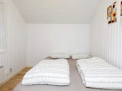 two beds in a room with white walls at 8 person holiday home in Højslev-By Traum in Højslev