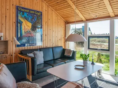 a living room with a couch and a table at 9 person holiday home in Harboøre-By Traum in Harboør