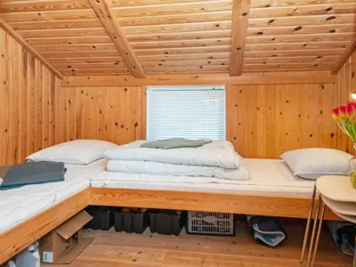a room with two beds in a wooden cabin at 9 person holiday home in Harboøre-By Traum in Harboør