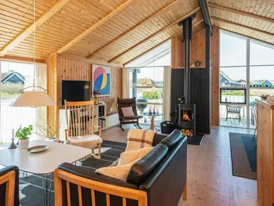 a living room with a couch and a fireplace at 9 person holiday home in Harboøre-By Traum in Harboør