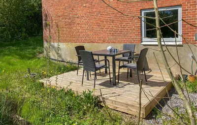 a table and chairs sitting on a wooden deck at Beautiful Apartment In Hurup Thy in Heltborg