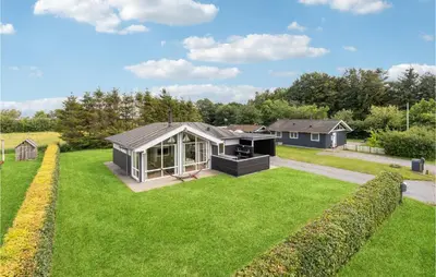 a house in a garden with a large lawn at 3 Bedroom Lovely Home In Farsø in Farsø