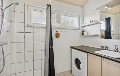 a bathroom with a shower and a washing machine at 3 Bedroom Lovely Home In Farsø in Farsø