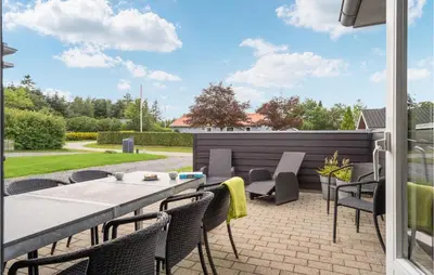 a patio with a table and chairs on a patio at 3 Bedroom Lovely Home In Farsø in Farsø