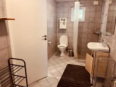 a bathroom with a toilet and a sink at Gittes hus in Skive