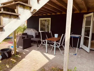 a patio with a table and chairs on it at Gittes hus in Skive