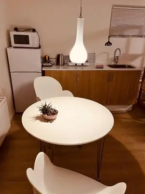a kitchen with a white table and chairs at Gittes hus in Skive